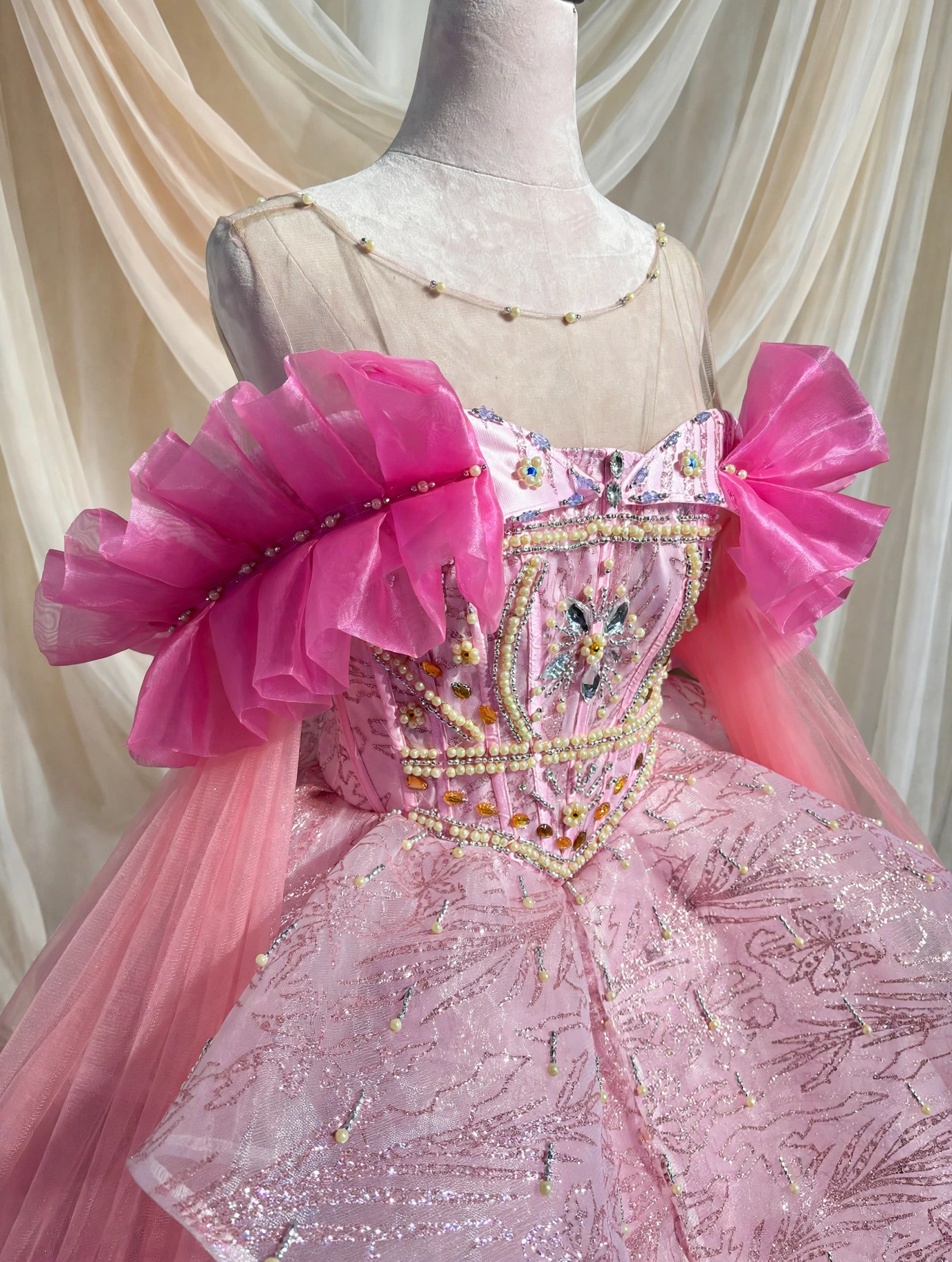 Close-up of hand-beaded bodice on pink quinceanera dress