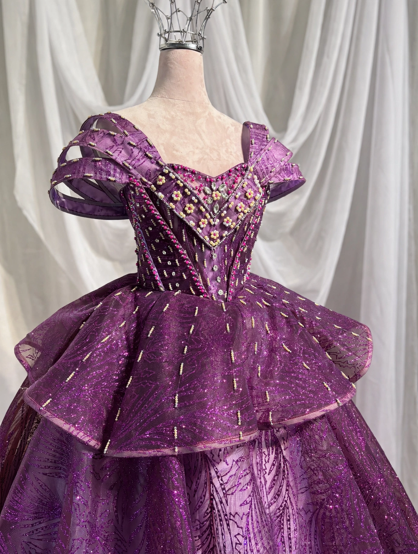 Close-up of hand-beaded bodice on purple quinceanera dress