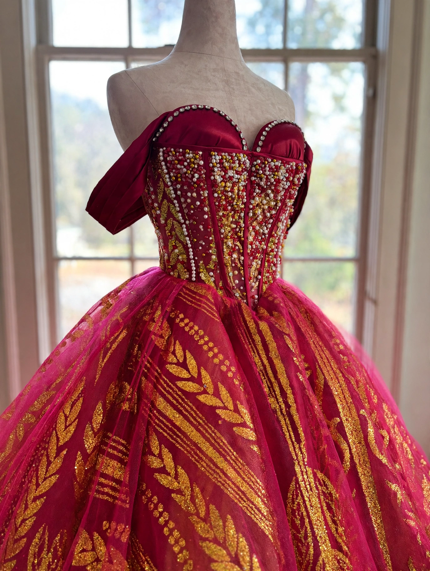 Close-up of beaded sweetheart corset on red quinceanera dress