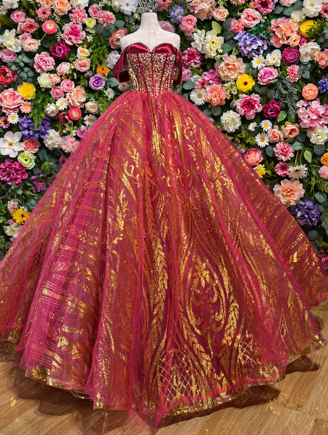 Red and gold quinceanera dress on mannequin, full view