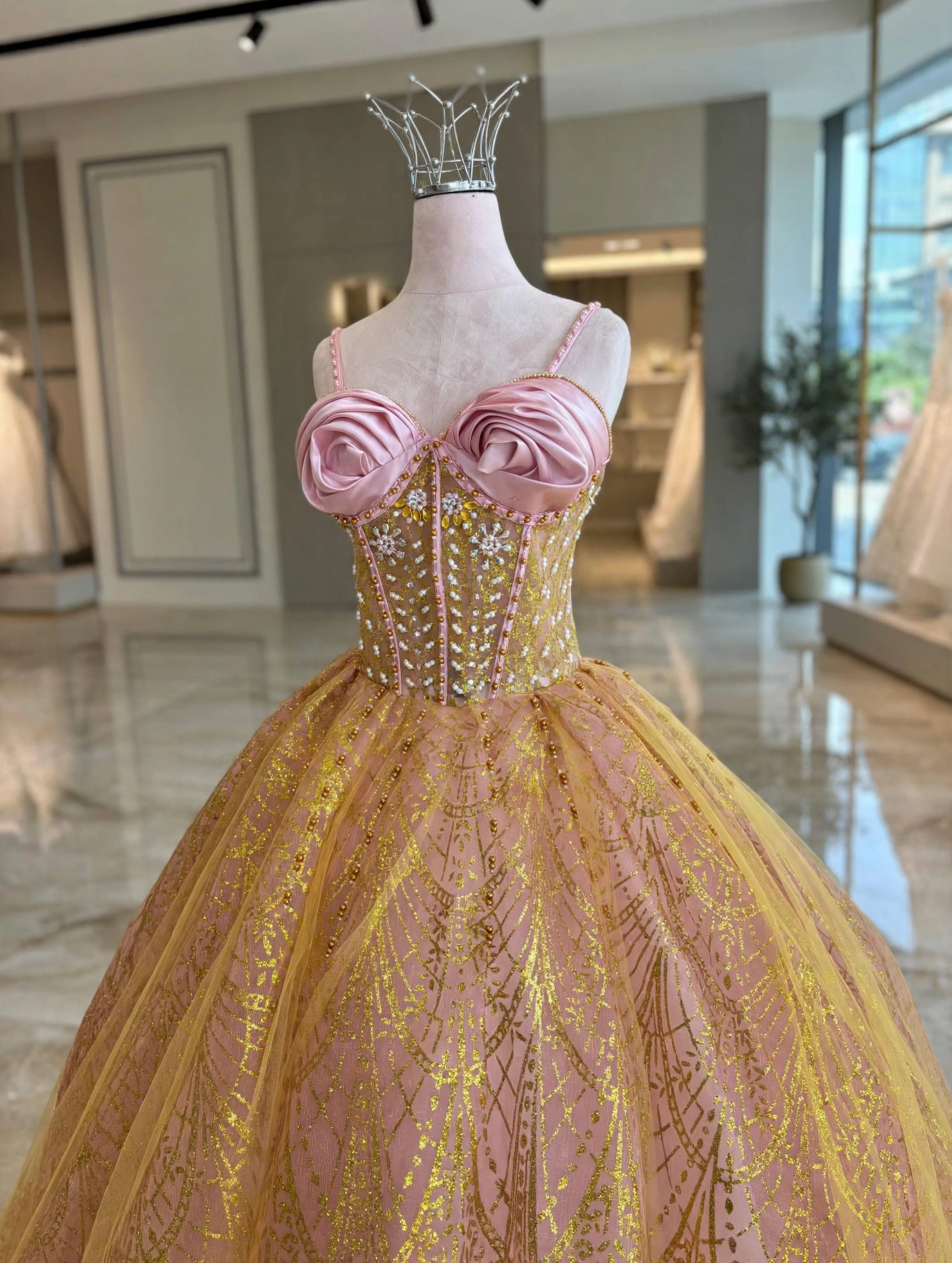 Close-up of gold embroidery and 3D flowers on champagne dress