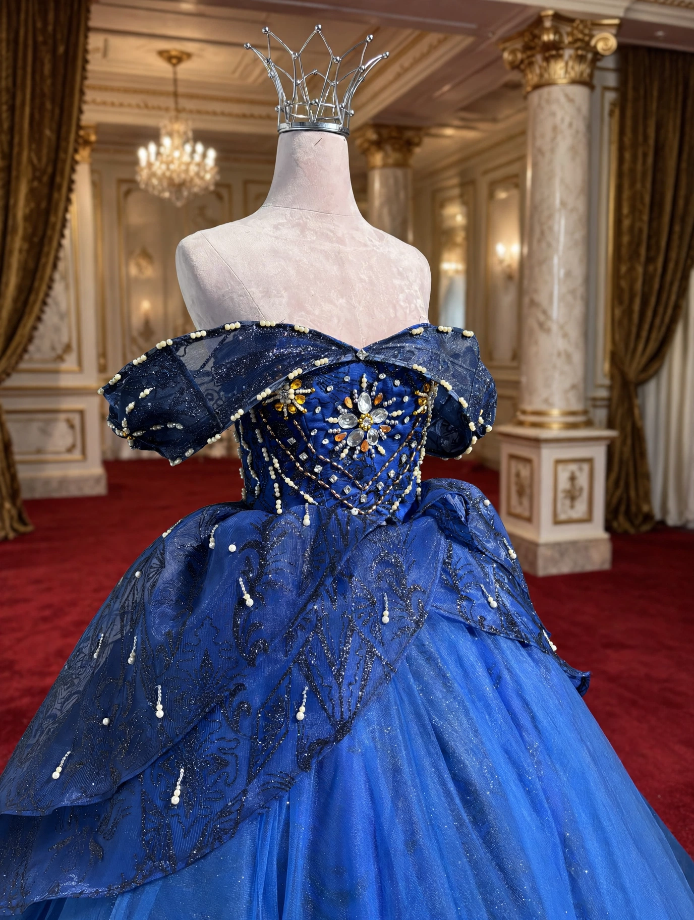 Close-up of sunburst beadwork on royal blue bodice