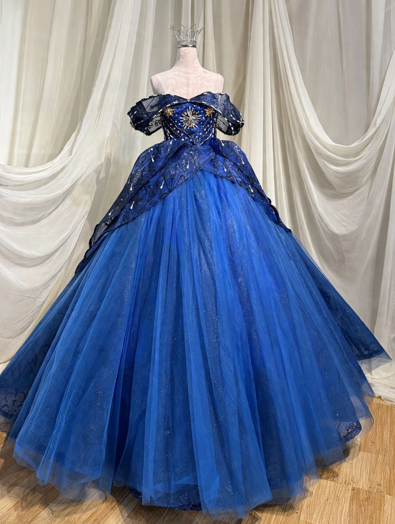 Royal blue quinceanera dress with sunburst beading, front view
